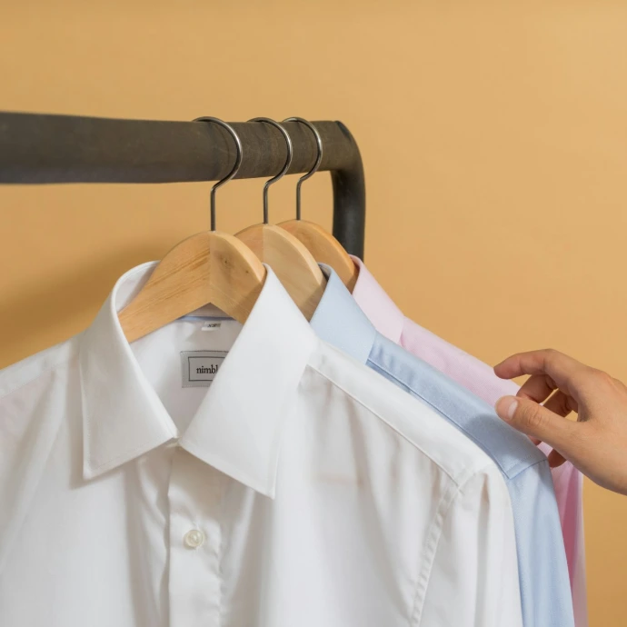 white button up shirt on black clothes hanger